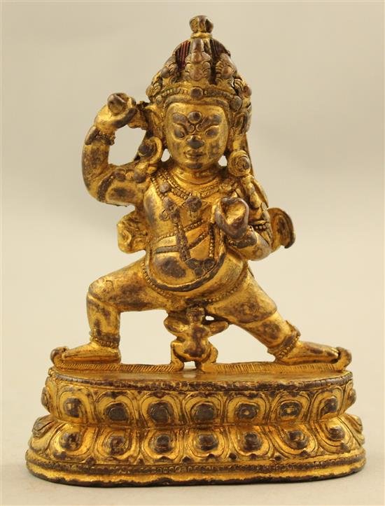 A Tibetan gilt copper bronze figure of Mahakala, 18th / 19th century, 10.5cm.